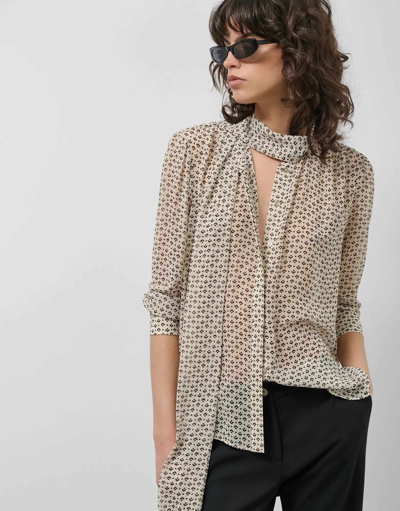 Blusa con lazada estampado geométrico blanco y negro