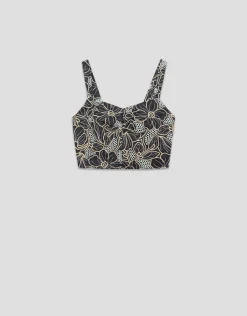 Crop top en tejido vaquero azul con bordado floral y calados
