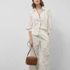 Pantalón palazzo con diseño floral en devoré blanco